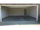 An empty two car garage with installed shelving and a door to the home's interior at 1906 Hawfields Crossing Ln, Mebane, NC 27302