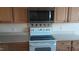 Well-equipped kitchen with stainless steel microwave, oven, and white countertops at 1906 Hawfields Crossing Ln, Mebane, NC 27302