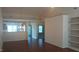 Open-concept living room with wood flooring, built in shelves, and a view to the kitchen at 1906 Hawfields Crossing Ln, Mebane, NC 27302