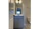 Bathroom vanity showcasing shaker-style cabinets, quartz countertop, and an open doorway to another room at 1913 Fishamble St, Fuquay Varina, NC 27526