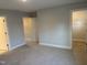 Spacious bedroom with plush neutral carpet and doorways to ensuite bath and walk-in closet at 1913 Fishamble St, Fuquay Varina, NC 27526