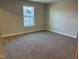 Bedroom featuring neutral walls, trim, and carpet and a window offering neighborhood views at 1913 Fishamble St, Fuquay Varina, NC 27526
