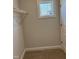 Walk-in closet, displaying wire shelving, neutral walls, plush carpeting, and a window for natural light at 1913 Fishamble St, Fuquay Varina, NC 27526