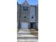Charming townhome exterior features a one car garage and a gray brick and siding facade at 1913 Fishamble St, Fuquay Varina, NC 27526