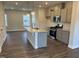 Open-concept kitchen with a granite island, stainless steel appliances, and pendant lighting at 1913 Fishamble St, Fuquay Varina, NC 27526