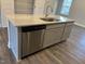 Kitchen island featuring a stainless steel dishwasher, granite countertop, and gray cabinets at 1913 Fishamble St, Fuquay Varina, NC 27526