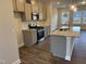 Modern kitchen with stainless steel appliances, granite countertops, and gray cabinets at 1913 Fishamble St, Fuquay Varina, NC 27526