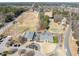 Aerial view showcasing the community clubhouse, golf course, and surrounding residential area and roads at 1928 Jupiter Hills Ct, Raleigh, NC 27604
