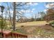 Lush backyard with shade trees and a stone path leading to a bench at 1928 Jupiter Hills Ct, Raleigh, NC 27604