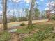 Serene backyard featuring a hammock, mature trees, and a lush lawn at 1928 Jupiter Hills Ct, Raleigh, NC 27604