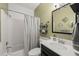 Bathroom with a shower-tub combo, commode, and sink with black colored cabinets at 1928 Jupiter Hills Ct, Raleigh, NC 27604