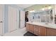 Bright bathroom boasts double sinks, a large mirror, and white tiled floors at 1928 Jupiter Hills Ct, Raleigh, NC 27604
