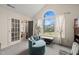 Bright bedroom featuring large arched window, French doors, and comfortable seating at 1928 Jupiter Hills Ct, Raleigh, NC 27604