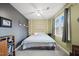 Cozy bedroom featuring a ceiling fan, a window with natural light, and modern decor at 1928 Jupiter Hills Ct, Raleigh, NC 27604