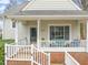 Inviting front porch with white railings, brick foundation, and outdoor seating for relaxing at 1928 Jupiter Hills Ct, Raleigh, NC 27604