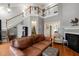 Bright living room with a cozy fireplace, hardwood floors, and a staircase to the second floor at 1928 Jupiter Hills Ct, Raleigh, NC 27604