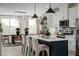 Open kitchen featuring modern island, stainless appliances, and dining area at 2118 Opulent Oaks Ln # 10, Durham, NC 27713