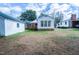 View of the back of the home with wood deck and bright sun room at 229 Short St, Wendell, NC 27591