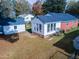 View of back of the home showing sunroom addition and detached garage at 229 Short St, Wendell, NC 27591