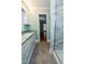 Bathroom with a white shower with a marble-like surround and a white sink with white cabinets at 229 Short St, Wendell, NC 27591