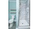 Modern bathroom with a sleek shower, toilet, and floating shelves for a minimalist design at 229 Short St, Wendell, NC 27591