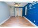 Charming bedroom with laminate floors, a closet with shelves, and crane artwork at 229 Short St, Wendell, NC 27591