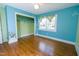 Brightly painted ' bedroom with hardwood floors and closet with painted accents at 229 Short St, Wendell, NC 27591