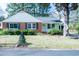Charming red brick home with white trim, shutters, and landscaped front yard at 229 Short St, Wendell, NC 27591