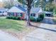 Well-maintained red brick home with a green lawn and detached garage at 229 Short St, Wendell, NC 27591