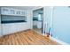 Kitchen boasts wood floors, ample cabinet space, and blue countertops, creating a cozy cooking environment at 229 Short St, Wendell, NC 27591
