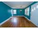 Cozy living room boasts hardwood floors, natural light from bright windows, and neutral wall color at 229 Short St, Wendell, NC 27591