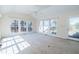 Bright living room with neutral carpet, ceiling fan, and expansive windows at 229 Short St, Wendell, NC 27591