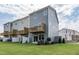A view of backyard featuring lush green lawn, attached deck and patio areas, ideal for outdoor living at 2323 Bay Minette Sta # 547, Apex, NC 27502