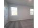 Neutral bedroom with carpet, two windows, and a closet door at 2323 Bay Minette Sta # 547, Apex, NC 27502