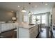 Open kitchen boasts a large island with a sink, pendant lighting, and modern appliances at 2323 Bay Minette Sta # 547, Apex, NC 27502