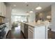Spacious kitchen showcases an island with a sink, white cabinets, and stainless steel appliances at 2323 Bay Minette Sta # 547, Apex, NC 27502