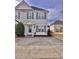 Charming townhome featuring light yellow siding and blue shutters, with a concrete driveway and tidy landscaping at 2323 Turtle Point Dr, Raleigh, NC 27604