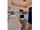 Efficient kitchen with white cabinets, laminate countertops, and modern appliances, enhanced by natural light and plants at 2323 Turtle Point Dr, Raleigh, NC 27604