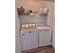 Convenient laundry area with a washer and dryer; shelving provides space for storing supplies at 2323 Turtle Point Dr, Raleigh, NC 27604
