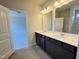Bathroom features double sink vanity, neutral walls and tile flooring at 253 Deodora Ln, Cameron, NC 28326