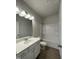 Well-lit bathroom features modern vanity, a large mirror, and a shower-tub combination at 253 Deodora Ln, Cameron, NC 28326