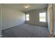 Bright bedroom with carpet, large windows allowing for natural light, and neutral walls at 253 Deodora Ln, Cameron, NC 28326