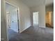Inviting hallway features neutral walls, carpet flooring, and doors leading to various rooms at 253 Deodora Ln, Cameron, NC 28326