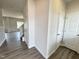 Hallway showcasing contemporary design with neutral walls and wood-look flooring at 253 Deodora Ln, Cameron, NC 28326