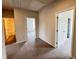 Upstairs hallway with neutral carpet leading to the bedrooms and bathroom at 253 Deodora Ln, Cameron, NC 28326