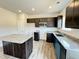Modern kitchen features granite countertops, island, stainless microwave, dishwasher and stylish cabinets at 253 Deodora Ln, Cameron, NC 28326