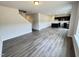 Open-concept living room featuring sleek hardwood flooring and seamless access to the modern kitchen at 253 Deodora Ln, Cameron, NC 28326