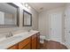Bathroom with dual sinks, wood vanity, two mirrors, and modern faucets at 264 Farrington Dr, Clayton, NC 27520