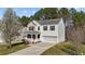 Charming two-story home with a well-maintained lawn and an inviting front porch at 264 Farrington Dr, Clayton, NC 27520