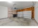 Spacious and well-lit garage featuring an automatic door, storage shelves, and ample room for parking at 264 Farrington Dr, Clayton, NC 27520
